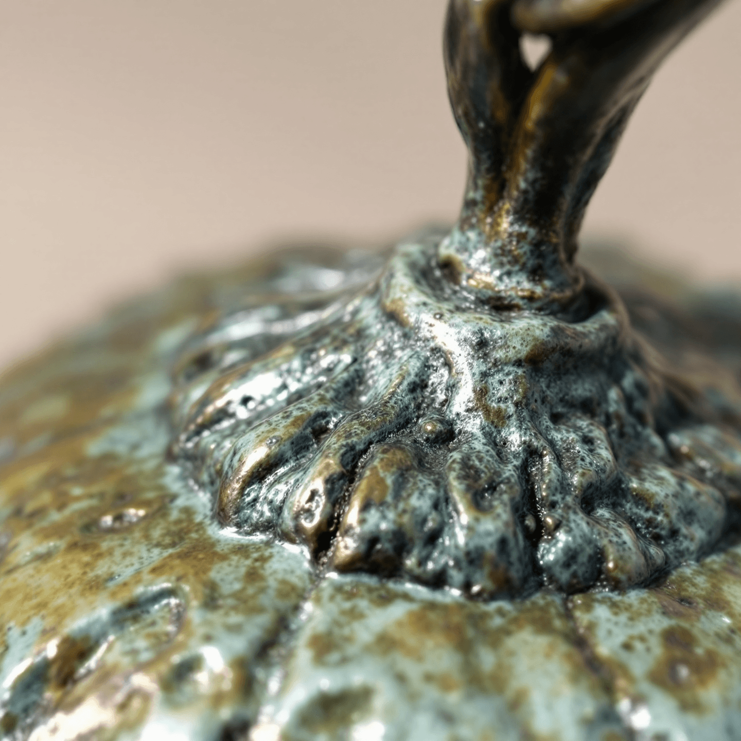 cast bronze lemon with brushed cool patina — macro close-up showing material seam and surface detail, off-white seamless background, raking north-window light